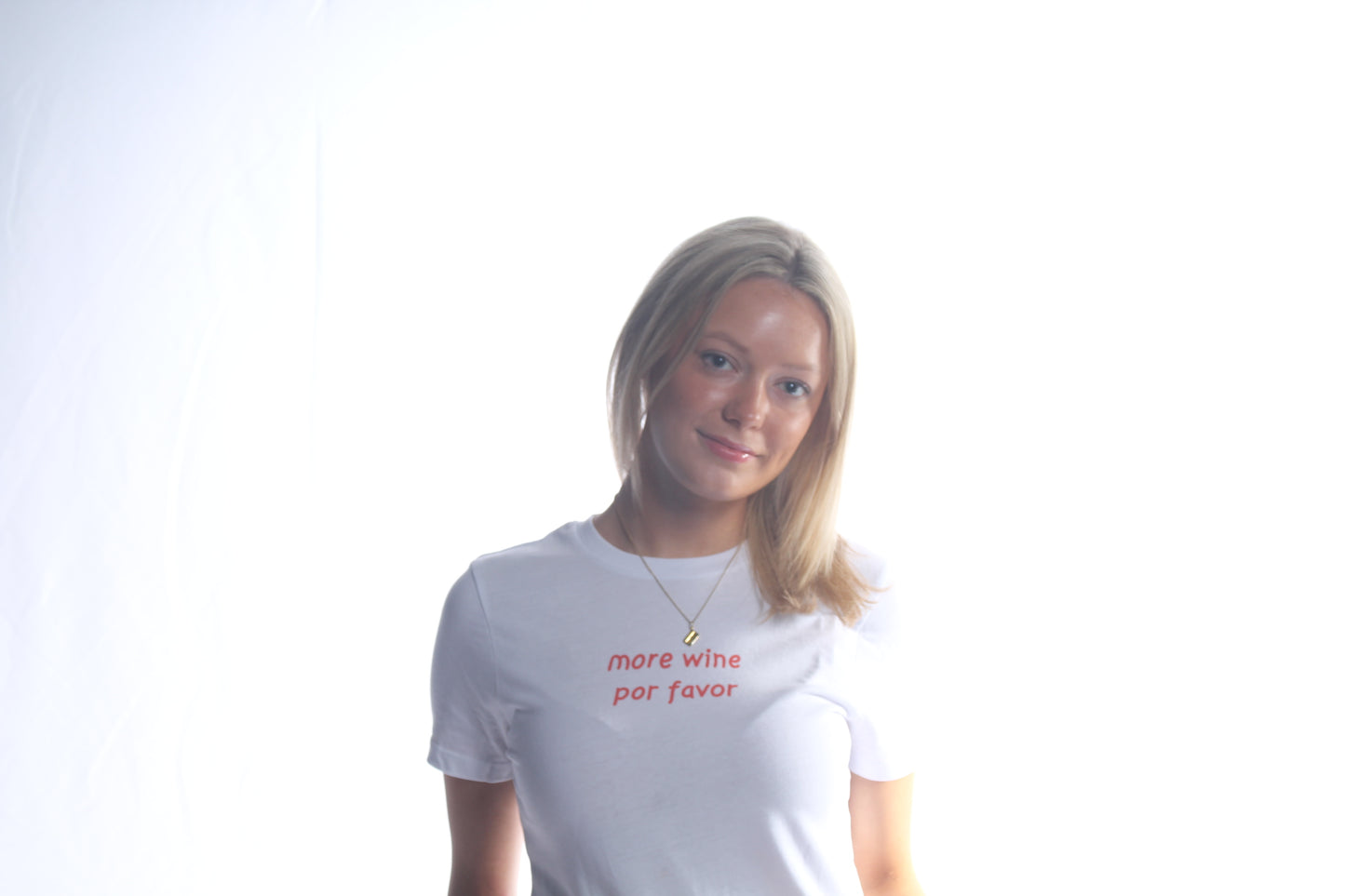 The More Wine Por Favor Baby Tee White